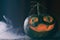 Halloween Pumpkin with carved smiling face on wooden table with spooky blue mist