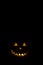 Halloween pumpkin in the dark with lighted candle inside. horror theme and Hallowe`en