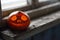 Halloween pumpkin on the dirty window sill of an old house window. Big spooky helloween symbol. Selective focus