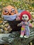 Halloween pumpkin in a disposable mask along with a gang of scary toys against a background of autumn foliage