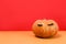 Halloween pumpkin with false eyelashes on red. Minimal Holiday season concept background