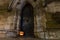 Halloween pumpkin in front of ancient wooden door and stone wall of a church, Germany