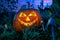 Halloween pumpkin in the garden at night with the eyes of the gears of the clock with the teeth of the metal parts