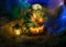 Halloween pumpkin head jack lantern with burning candles in a scary deep night garden, Glowing burning face, lighted background,