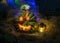 Halloween pumpkin head jack lantern with burning candles in a scary deep night garden, Glowing burning face, lighted background,