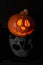 Halloween pumpkin head lantern on black background. Jack-o-lantern carved pumpkins for Halloween close up. Halloween pumpkin with