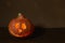Halloween pumpkin head lantern on wooden background . Jack-o-lantern carved pumpkins for Halloween close up. Halloween pumpkin