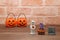 Halloween pumpkin Jack O\' lantern, grave, and mummy on wood.