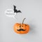 Halloween pumpkin Jack o Lantern with mustache and speech bubble on gray background