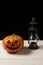 Halloween pumpkin and lamp. Happy Halloween holiday background with old vintage lamp