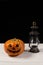 Halloween pumpkin and lamp. Happy Halloween holiday background with old vintage lamp