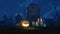 Halloween pumpkin and lighted candles near tombstone