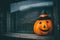 Halloween pumpkin look out dark window. Halloween party decoration