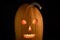 Halloween pumpkin with luminous glowing eyes .isolated on a black background.