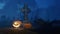 Halloween pumpkin near cross tombstone at night