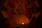 Halloween pumpkin`s grin inside illuminated by a candle. Halloween Pumpkin Head. Spooky pumpkin lantern in the darkness