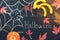 Halloween, pumpkin slice, spider, red maple leaves, spider web drawn in chalk on a dark rustic background. Signboard with with tex