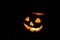 Halloween pumpkin smile and scrary eyes in darkness