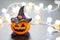 Halloween pumpkin tangerine with black witches hat