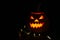 Halloween pumpkin on a tree stump on a dark night