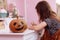 Halloween pumpkin on wooden table in schoolgirls room. child girl on backgroung doing homework