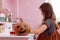 Halloween pumpkin on wooden table in schoolgirls room. child girl on backgroung doing homework