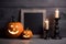 Halloween pumpkins, candle and lantern with mock up blank wooden frame chalkboard on dark bakground. Generative AI