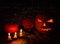 Halloween pumpkins with candles  amid old brick wall. Big spooky helloween symbol