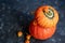 Halloween Pumpkins lie on burlap, next to dry greens