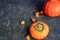 Halloween Pumpkins lie on burlap, next to dry greens