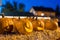 Halloween pumpkins at night on hay bale.