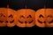 Halloween pumpkins paper garland with happy face on dark background