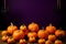 Halloween pumpkins rest on rustic wooden surface, evoking autumn charm