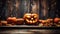 Halloween pumpkins in vintage barn at night on dark wood background