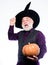 Halloween is a real treat. Stargazer in holiday costume. Traditional food. evil wizard hold orange pumpkin. happy