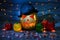 Halloween`s Eve. Jack-o-lantern in a hat and candles inside, scaring face lights isolated night dark background blue grightening
