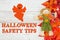 Halloween safety tips message with red and orange fall leaves with a scarecrow