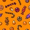 Halloween seamless pattern with cartoon candies on the orange background. Vector.