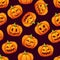 Halloween seamless pattern with different funny emotions of pumpkins