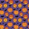 Halloween seamless pattern with orange pumpkins carved faces and black bats on ultraviolet background
