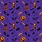 Halloween seamless pattern with pumpkin, pen, bat, hat, poison, spider, web, dots on violet background.