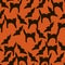 Halloween seamless  pattern for your design  with black silhouette of pumpkins, cats, spiders and witches on a orange