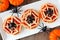 Halloween spider web mini pizzas, table scene on white plate