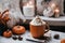 halloween still life with latte, decorations and pumpkins , holiday background