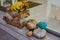 Halloween street decor. Autumn flowers and modern golden and silver pumpkins at store front, festive decoration of city street.