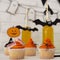Halloween stylized yellow cocktails and cup cakes