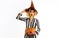 Halloween surprised witch with magic pumpkin. Beautiful woman in witches hat with Jack-o-lantern.