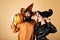 Halloween surprised woman and handsome bearded man in Halloween hat and costume holding pumpkin. Happy family