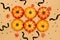 Halloween symbol concept, Scary smile pumpkins with maple leaves are arranged on cream background