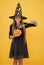 halloween teen girl in witch hat hold magic wand and pumpkin jack o lantern for witchcraft, happy halloween